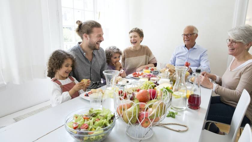Happy extended family having lunch at home