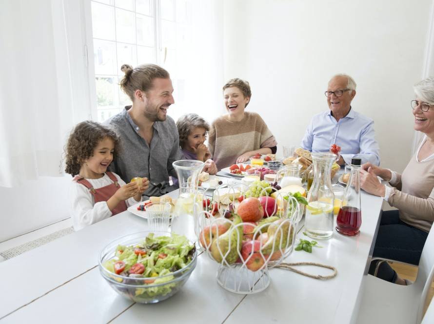 Happy extended family having lunch at home