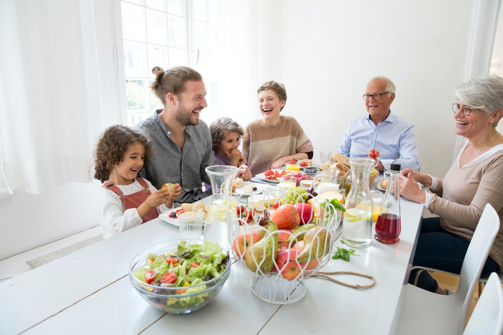 Happy extended family having lunch at home